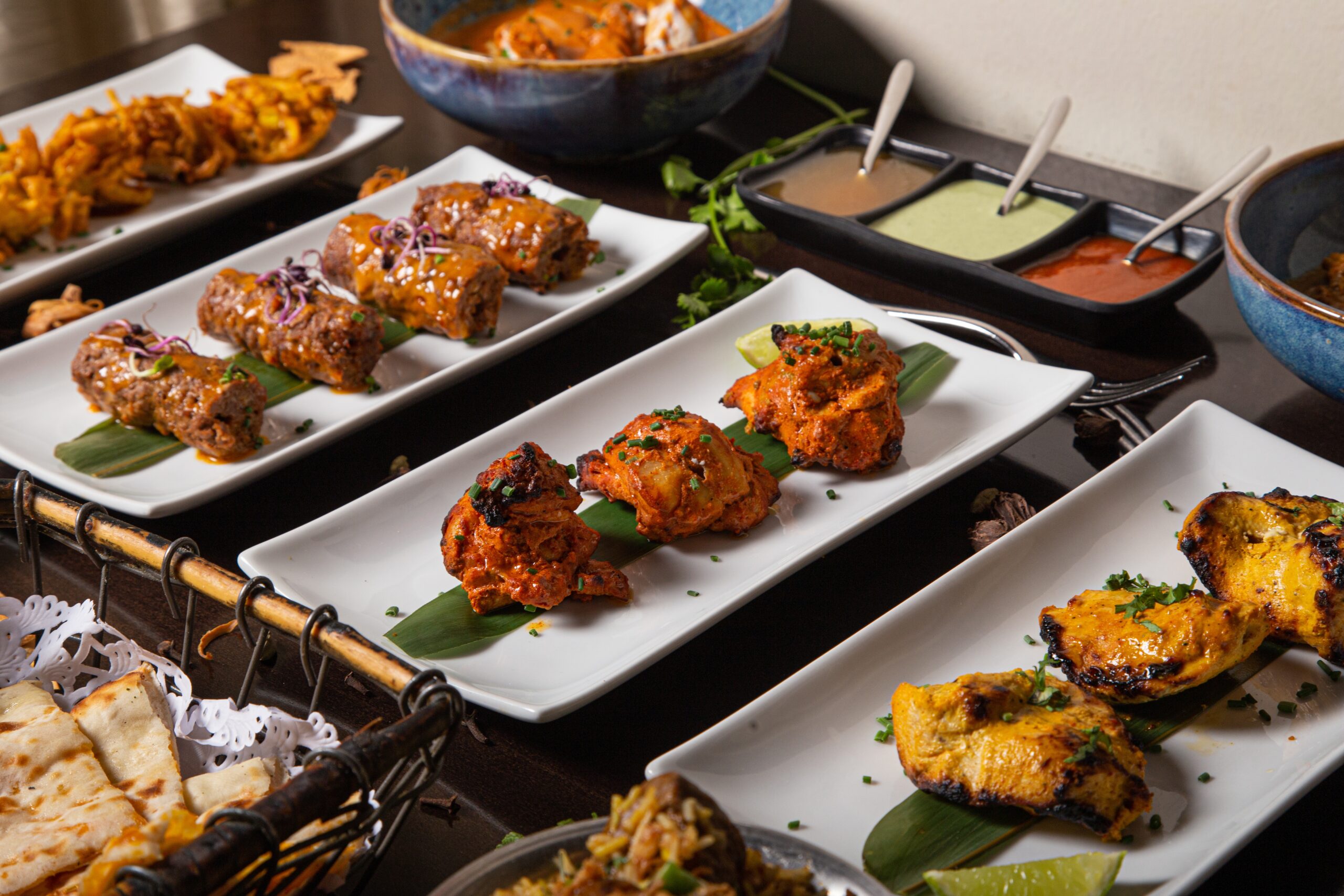 A dinner table with fried meat dishes and sauces